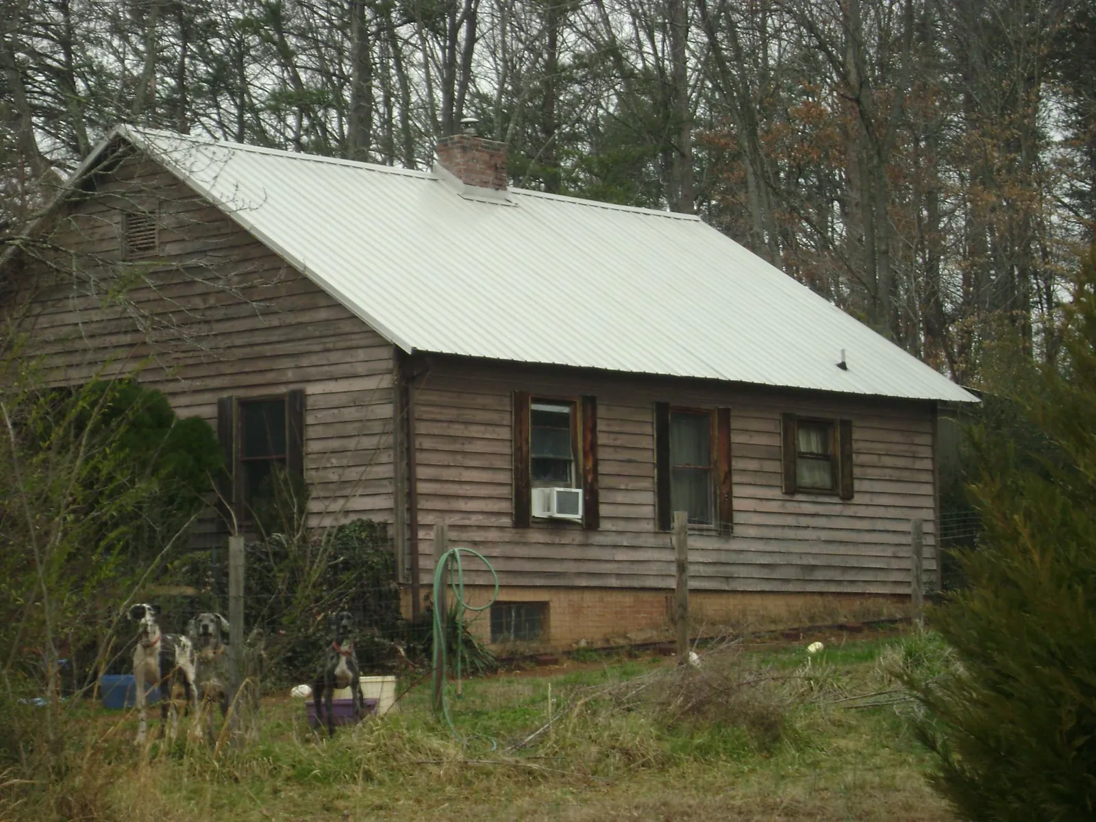 White metal roof on an old wood sided farmhouse, from a Metal Roof Installation job in Odell